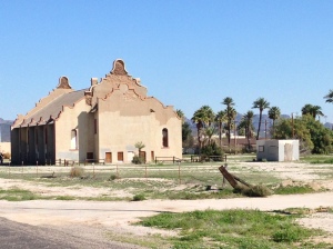 An abandoned Baptist Church made of adobe.